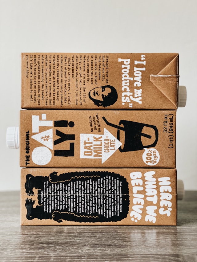 A stack of Oatly cartons displaying innovative packaging